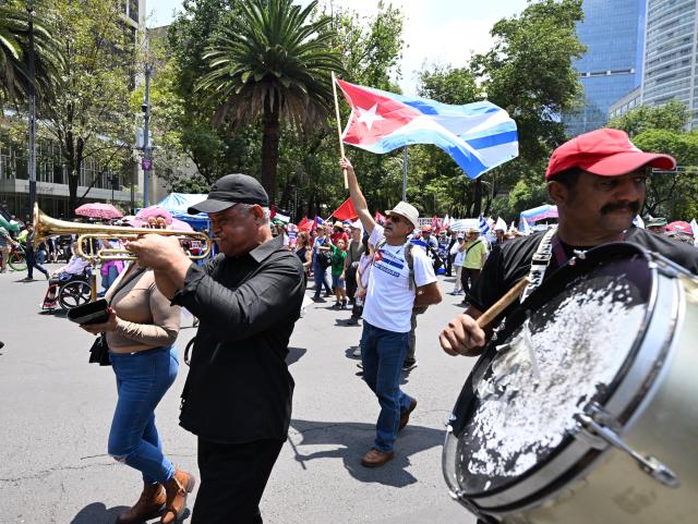 (260726) -- MEXICO CITY, July 26, 2026 (Xinhua) -- Protesters march during a demonstration in support of Cuba and against U.S. embargo on Cuba, in Mexico City, Mexico on July 26, 2026. The demonstration aimed to commemorate the 73rd anniversary of the assault on Moncada and Carlos Manuel de Cespedes garrisons that took place on July 26, 1953, seen as the beginning of the Cuban Revolution. (Xinhua/Wu Wei)