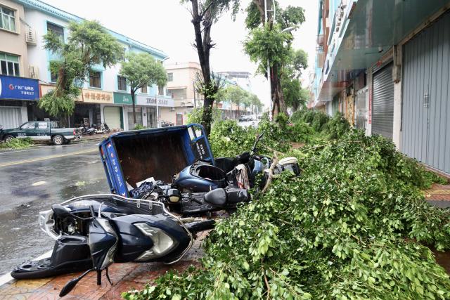 (260727) -- BEIJING, July 27, 2026 (Xinhua) -- Overturned vehicles and fallen trees are pictured in Pinghai Town of Huidong County, Huizhou, south China's Guangdong Province, July 26, 2026. China's national commission for disaster prevention, reduction and relief on Sunday activated a Level-IV national disaster relief emergency response for south China's Guangdong Province after the region was severely affected by Typhoon Noul, the 12th typhoon of the year. (Xinhua/Lu Hanxin)
