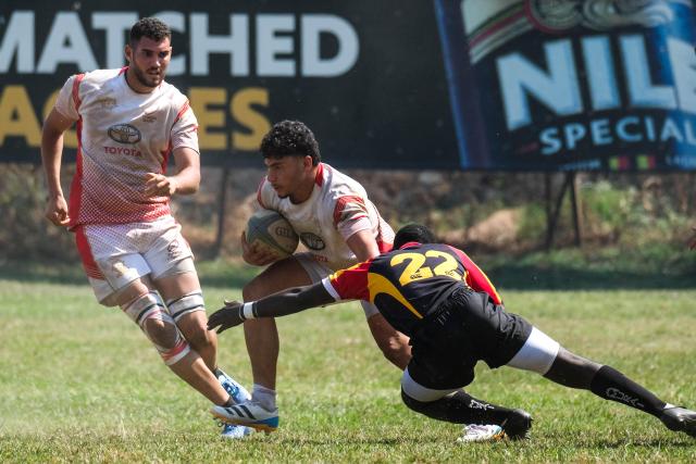 (260727) -- KAMPALA, July 27, 2026 (Xinhua) -- Achraf Hichri (C) of Tunisia and Arthur Kato (R) of Uganda compete during an international U20 rugby test match between Uganda and Tunisia held for the upcoming 2026 Barthes Trophy in Kampala, Uganda on July 26, 2026. The Barthes Trophy, which will take place from August 4 to 17, is the only national-level junior rugby tournament in Africa, with eight U20 teams competing for the title. (Photo by Hajarah Nalwadda/Xinhua)