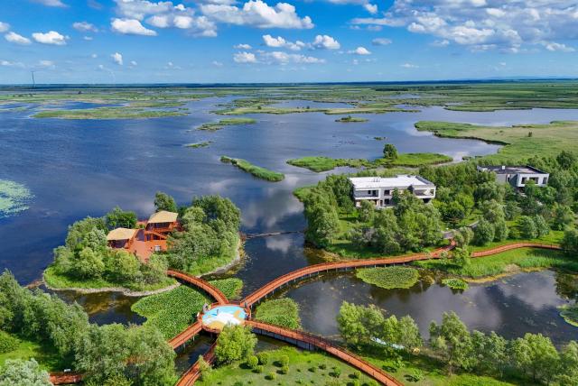 (260727) -- FUJIN, July 27, 2026 (Xinhua) -- A drone photo taken on July 16, 2026 shows a view of the Fujin National Wetland Park in Fujin City, northeast China's Heilongjiang Province. Thanks to years of ecological restoration, the Fujin National Wetland Park now features a thriving ecosystem and breathtaking natural beauty. (Photo by Qu Yubao/Xinhua)
