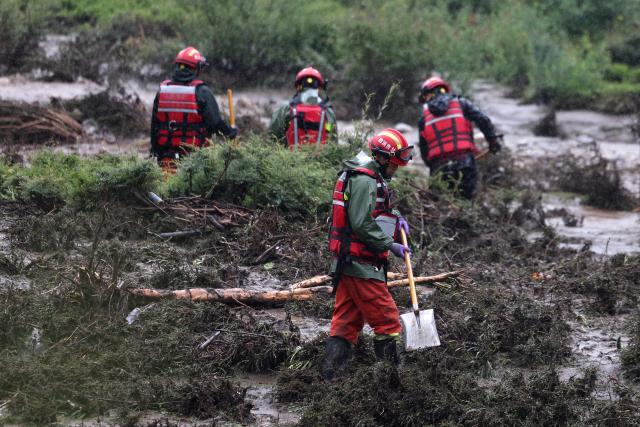 (260727) -- WEIYUAN, July 27, 2026 (Xinhua) -- Rescuers work at the flood-hit area in Weiyuan County, northwest China's Gansu Province, July 27, 2026. The flash flood, triggered by sudden heavy rainfall, hit a scenic area in Weiyuan County, Dingxi City, on Sunday afternoon, leaving 10 people dead and 23 injured as of 6 p.m.
   Some tourists were camping in the scenic area and were trapped after the flood burst out, local authorities said.
   A total of 305 rescue personnel with 68 vehicles from the national comprehensive fire and rescue teams are conducting rescue operations at the site, according to the MEM. (Xinhua/Chen Bin)