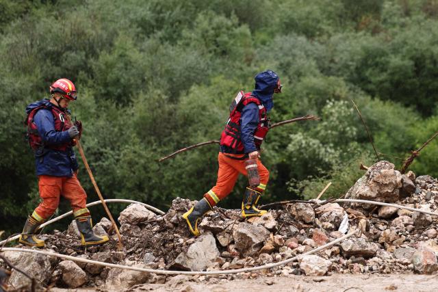 (260727) -- WEIYUAN, July 27, 2026 (Xinhua) -- Rescuers work at the flood-hit area in Weiyuan County, northwest China's Gansu Province, July 27, 2026. The flash flood, triggered by sudden heavy rainfall, hit a scenic area in Weiyuan County, Dingxi City, on Sunday afternoon, leaving 10 people dead and 23 injured as of 6 p.m.
   Some tourists were camping in the scenic area and were trapped after the flood burst out, local authorities said.
   A total of 305 rescue personnel with 68 vehicles from the national comprehensive fire and rescue teams are conducting rescue operations at the site, according to the MEM. (Xinhua/Chen Bin)