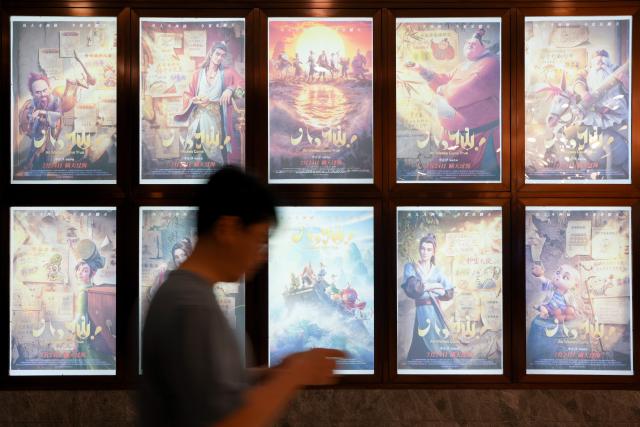 (260727) -- BEIJING, July 27, 2026 (Xinhua) -- A person walks past posters of Chinese film "All Wishes Come True" at a cinema in Chengdu, southwest China's Sichuan Province, on July 23, 2026. (Xinhua/Xu Bingjie)