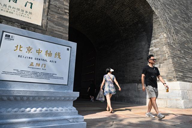 (260727) -- BEIJING, July 27, 2026 (Xinhua) -- Visitors walk through the Zhengyangmen Gate in Beijing, capital of China, July 27, 2026. Marking the second anniversary of the successful inscription of the Beijing Central Axis on the UNESCO World Heritage List, heritage sites along the central axis, such as the Palace Museum, Zhengyangmen Gate, and Altar of the God of Agriculture, also referred to as the Xiannongtan Temple, were opened to the public, and some sites launched new exhibitions on Monday.
   Stretching 7.8 kilometers from Yongding Gate in the south to the Drum and Bell Towers in the north, the Beijing Central Axis was constructed based on ancient architectural philosophies to create an ideal layout for a capital city. The Central Axis can be traced back to the early Yuan Dynasty (1271-1368), and its length was extended in the Ming and Qing dynasties. (Xinhua/Chen Zhonghao)