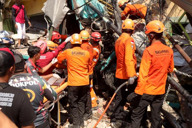 (260727) -- PASURUAN, July 27, 2026 (Xinhua) -- Rescuers work at the site of a multiple-vehicle crash in Pasuruan Regency, East Java Province, Indonesia, July 27, 2026. Four people were killed and six others injured in a multi-vehicle crash involving a trailer truck carrying rolls of paper in Pasuruan regency, Indonesia's East Java province, on Monday morning, local police said.
   A local police officer said the trailer truck was believed to have lost control and collided with two trucks traveling in the opposite direction. (Photo by Robby/Xinhua)