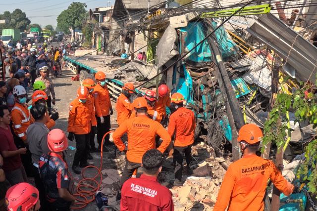 (260727) -- PASURUAN, July 27, 2026 (Xinhua) -- Rescuers work at the site of a multiple-vehicle crash in Pasuruan Regency, East Java Province, Indonesia, July 27, 2026. Four people were killed and six others injured in a multi-vehicle crash involving a trailer truck carrying rolls of paper in Pasuruan regency, Indonesia's East Java province, on Monday morning, local police said.
   A local police officer said the trailer truck was believed to have lost control and collided with two trucks traveling in the opposite direction. (Photo by Robby/Xinhua)