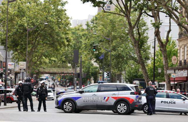 (260727) -- PARIS, July 27, 2026 (Xinhua) -- Policemen and police vehicles are seen near the site of a knife attack in Paris, France, July 27, 2026. Three people were injured in a knife attack in Paris on Monday, and a male suspect was arrested.
   The attack occurred at around 11:30 a.m. local time in northwestern Paris, where a man armed with two kitchen knives attacked passersby on the street. The victims received medical treatment, with two of them in critical condition, according to French media reports. (Xinhua/Wu Huiwo)