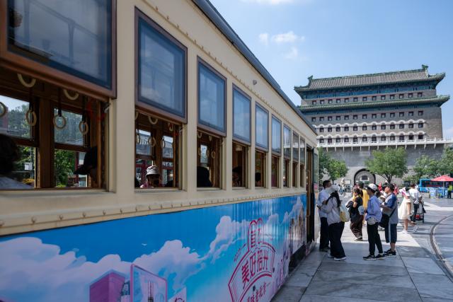 (260727) -- BEIJING, July 27, 2026 (Xinhua) -- People visit the Qianmen pedestrian street in Beijing, capital of China, July 27, 2026. The second anniversary of the inscription of the Beijing Central Axis on the UNESCO World Heritage List falls on July 27.
   Since its inscription, the 7.8-kilometer-long axis has continued to gain new vitality, attracting more visitors to experience Beijing's historical heritage amid the blend of ancient architecture and modern life, while bringing World Heritage closer to everyday life.
   Stretching from the Bell and Drum Towers in the north to Yongdingmen Gate in the south, the Beijing Central Axis reflects traditional Chinese urban planning and serves as the spatial backbone of the old city. Carrying the history of Beijing's urban development, it bears witness to the continuity of Chinese civilization and reflects the capital's evolution through the ages. (Xinhua/Hu Jingwen)