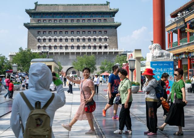 (260727) -- BEIJING, July 27, 2026 (Xinhua) -- People visit the Qianmen pedestrian street in Beijing, capital of China, July 27, 2026. The second anniversary of the inscription of the Beijing Central Axis on the UNESCO World Heritage List falls on July 27.
   Since its inscription, the 7.8-kilometer-long axis has continued to gain new vitality, attracting more visitors to experience Beijing's historical heritage amid the blend of ancient architecture and modern life, while bringing World Heritage closer to everyday life.
   Stretching from the Bell and Drum Towers in the north to Yongdingmen Gate in the south, the Beijing Central Axis reflects traditional Chinese urban planning and serves as the spatial backbone of the old city. Carrying the history of Beijing's urban development, it bears witness to the continuity of Chinese civilization and reflects the capital's evolution through the ages. (Xinhua/Hu Jingwen)