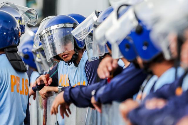 (260727) -- QUEZON CITY, July 27, 2026 (Xinhua) -- Police officers from the Philippine National Police gather to block the path of protesters during a rally, as President Ferdinand Romualdez Marcos Jr. delivers his 5th State of the Nation Address (SONA) at the House of Representatives, in Quezon City, the Philippines, on July 27, 2026. Various sectors took to the streets to voice their grievances over government policies. (Xinhua/Rouelle Umali)