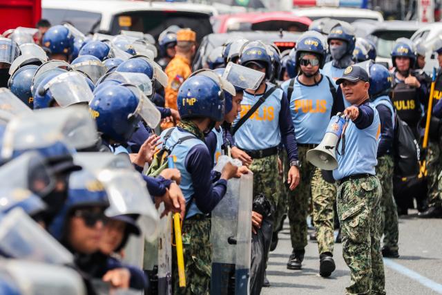 (260727) -- QUEZON CITY, July 27, 2026 (Xinhua) -- Police officers from the Philippine National Police gather to block the path of protesters during a rally, as President Ferdinand Romualdez Marcos Jr. delivers his 5th State of the Nation Address (SONA) at the House of Representatives, in Quezon City, the Philippines, on July 27, 2026. Various sectors took to the streets to voice their grievances over government policies. (Xinhua/Rouelle Umali)