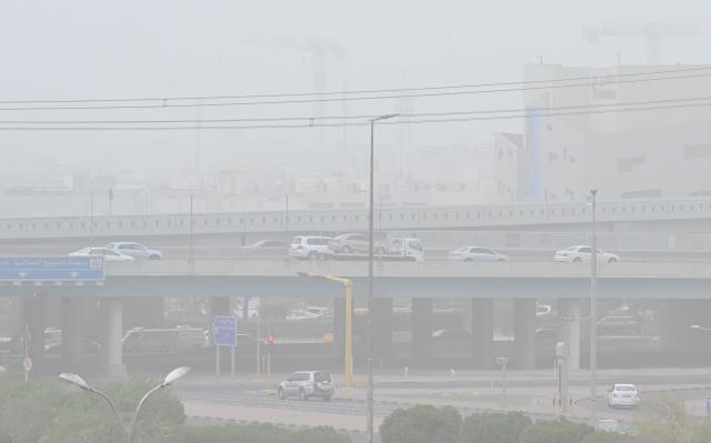 (260727) -- FARWANIYA GOVERNORATE, July 27, 2026 (Xinhua) -- Vehicles are seen on the road during a dust storm in Farwaniyah Governorate, Kuwait, July 27, 2026. (Photo by Asad/Xinhua)