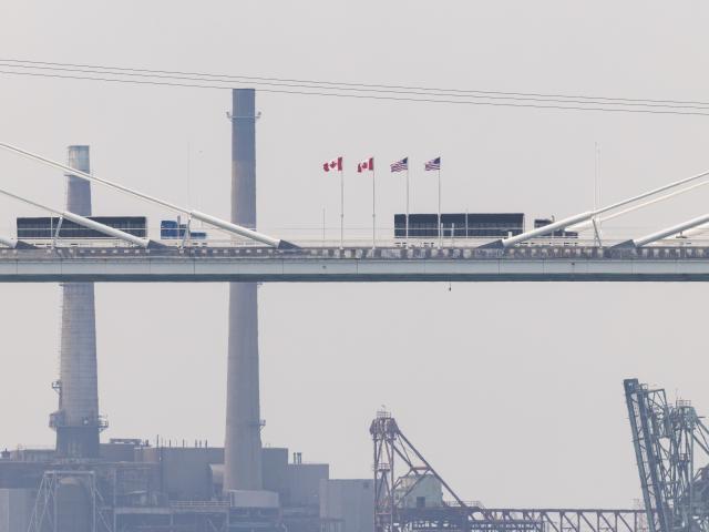 (260727) -- WINDSOR(CANADA), July 27, 2026 (Xinhua) -- Trucks heading into the United States on the Gordie Howe International Bridge are pictured from the Canadian side in Windsor, Ontario, Canada, on July 27, 2026. Canada on Monday opened a new international bridge linking Windsor, Ontario and Detroit, U.S., providing the newest and largest land border crossing with the United States despite escalating trade tensions between the two countries. (Photo by Zou Zheng/Xinhua)