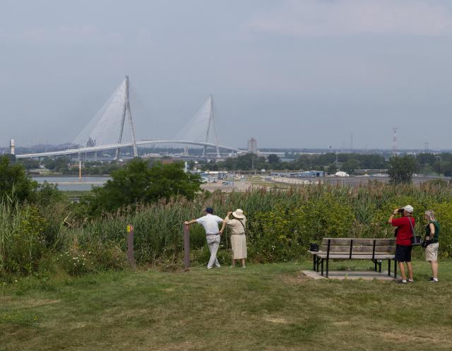 (260727) -- WINDSOR(CANADA), July 27, 2026 (Xinhua) -- People view the Gordie Howe International Bridge from the Canadian side in Windsor, Ontario, Canada, on July 27, 2026. Canada on Monday opened a new international bridge linking Windsor, Ontario and Detroit, U.S., providing the newest and largest land border crossing with the United States despite escalating trade tensions between the two countries. (Photo by Zou Zheng/Xinhua)