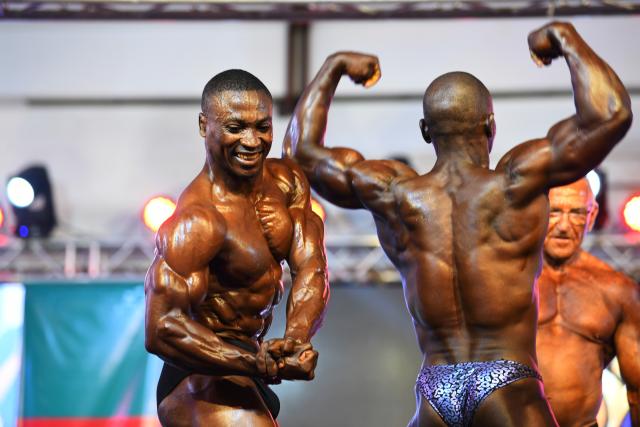 (260728) -- YAOUNDE, July 28, 2026 (Xinhua) -- Athletes flex their muscles during the World Fitness and Bodybuilding Championships Festival in Yaounde, Cameroon, on July 27, 2026. (Xinhua/Kepseu)