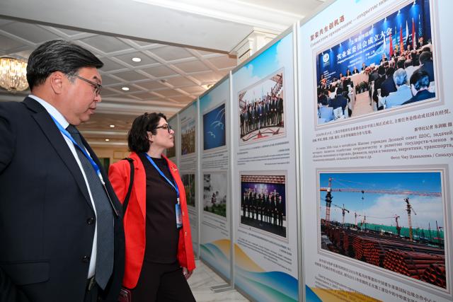 (260727) -- BISHKEK, July 27, 2026 (Xinhua) -- Guests visit a photo exhibition titled "Pooling the Strength of the SCO: Moving Toward Development and Prosperity" in Bishkek, Kyrgyzstan, July 27, 2026.
  A photo exhibition marking the 25th anniversary of the Shanghai Cooperation Organization (SCO) opened here on Monday.
  The exhibition features 32 photographs arranged in five sections: "A Shared Journey Over 25 Years," "Strengthening the Foundation for Safeguarding Peace," "Shared Prosperity: Unlocking New Opportunities," "Bridges Between Hearts: A Shared Future," and "A New Chapter for a Community with a Shared Future."
  Jointly organized by the SCO Secretariat and Xinhua News Agency, the exhibition showcases the organization's practical cooperation over the past quarter-century while capturing moments that reflect the growing friendship among the peoples of countries participating in the SCO framework. (Xinhua/Feng Kaihua)