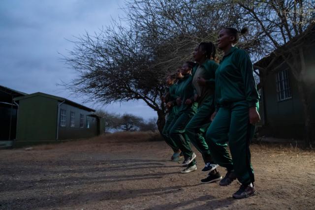 (260728) -- KAJIADO, July 28, 2026 (Xinhua) -- Members of Team Lioness do morning exercises at a camp in Ole Narika conservancy in Kajiado County, Kenya, July 22, 2026. TO GO WITH "Feature: All-female rangers boost wildlife conservation efforts in Kenya's Amboseli" (Xinhua/Xie Jianfei)
