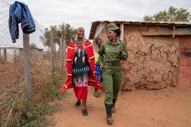 (260728) -- KAJIADO, July 28, 2026 (Xinhua) -- Purity Lakara (R), a team leader of Team Lioness, talks to a local Maasai villager at southern Amboseli in Kajiado County, Kenya, July 22, 2026. TO GO WITH "Feature: All-female rangers boost wildlife conservation efforts in Kenya's Amboseli" (Xinhua/Xie Jianfei)