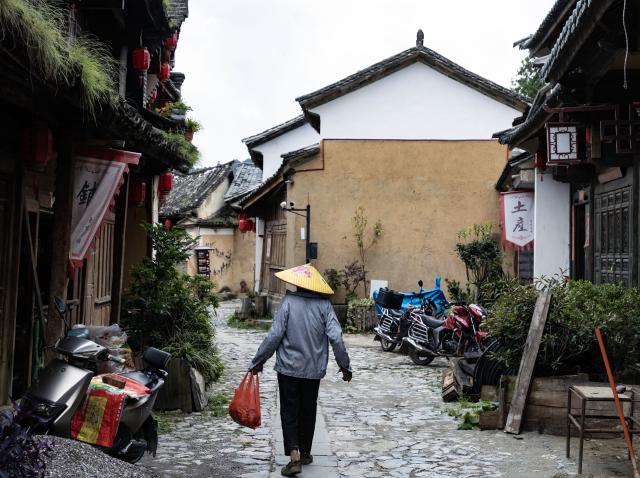 (260728) -- KUNMING, July 28, 2026 (Xinhua) -- This photo taken on July 26, 2026 shows an alleyway view in Lushi ancient town in Fengqing County of Lincang City in southwest China's Yunnan Province. Lushi ancient town in the northeast of Fengqing County lies between the Lancang River and Heihui River. Due to its special geographical location, Lushi was once an important trading hub on the ancient Tea Horse Road, a trade route dating back to the Tang Dynasty (618-907). The town has formed an unique culture that is influenced by merchants coming and going as well as multi-ethnic cohabitation. (Photo by Lan Hongguang/Xinhua)