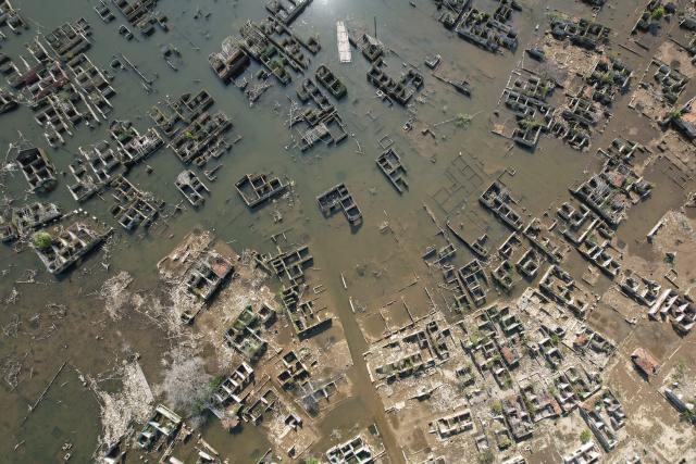 (260728) -- LEBAK, July 28, 2026 (Xinhua) -- An aerial drone photo taken on July 28, 2026 shows remains of houses re-emerging as the reservoir's water level drops in Lebak regency, Banten province, Indonesia. Due to the impact of El Nino, the dry season in Indonesia has been more intense and prolonged this year, with heightened risks of wildfires and droughts. (Xinhua/Veri Sanovri)