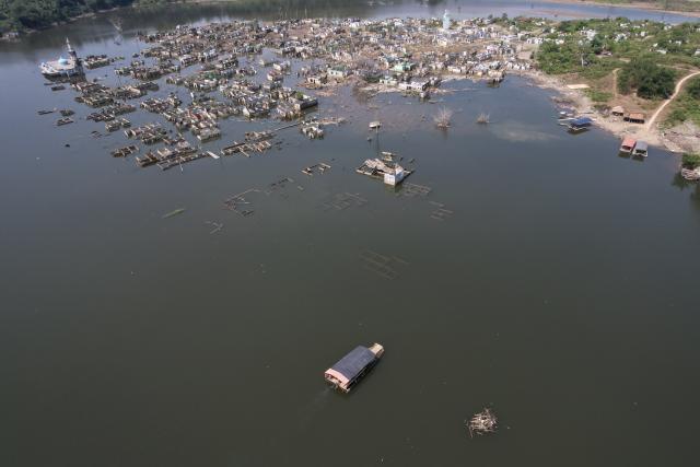 (260728) -- LEBAK, July 28, 2026 (Xinhua) -- An aerial drone photo taken on July 28, 2026 shows remains of houses re-emerging as the reservoir's water level drops in Lebak regency, Banten province, Indonesia. Due to the impact of El Nino, the dry season in Indonesia has been more intense and prolonged this year, with heightened risks of wildfires and droughts. (Xinhua/Veri Sanovri)
