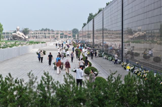 (260728) -- TANGSHAN, July 28, 2026 (Xinhua) -- An aerial drone photo taken on July 27, 2026 shows people mourning in front of a memorial wall inscribed with names of the victims at the Tangshan Earthquake Memorial Park in Tangshan, north China's Hebei Province. This year marks the 50th anniversary of the Tangshan Earthquake, a magnitude-7.8 quake that struck the city on July 28, 1976, taking the lives of more than 240,000 people and destroying virtually all buildings in the city.
   Crowds of people visited the Tangshan Earthquake Memorial Park on Tuesday to mourn and remember the victims in the devastating disaster. (Xinhua/Yang Shiyao)