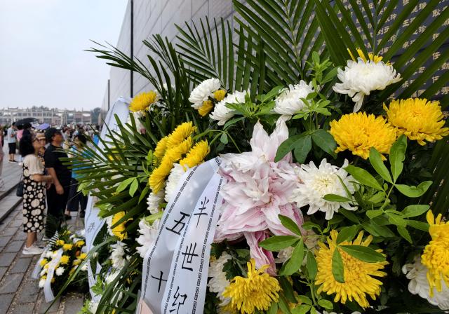 (260728) -- TANGSHAN, July 28, 2026 (Xinhua) -- People mourn in front of a memorial wall inscribed with names of the victims at the Tangshan Earthquake Memorial Park in Tangshan, north China's Hebei Province, July 28, 2026. This year marks the 50th anniversary of the Tangshan Earthquake, a magnitude-7.8 quake that struck the city on July 28, 1976, taking the lives of more than 240,000 people and destroying virtually all buildings in the city.
   Crowds of people visited the Tangshan Earthquake Memorial Park on Tuesday to mourn and remember the victims in the devastating disaster. (Xinhua/Yang Shiyao)