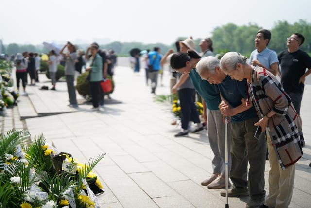 (260728) -- TANGSHAN, July 28, 2026 (Xinhua) -- People mourn in front of a memorial wall inscribed with names of the victims at the Tangshan Earthquake Memorial Park in Tangshan, north China's Hebei Province, July 28, 2026. This year marks the 50th anniversary of the Tangshan Earthquake, a magnitude-7.8 quake that struck the city on July 28, 1976, taking the lives of more than 240,000 people and destroying virtually all buildings in the city.
   Crowds of people visited the Tangshan Earthquake Memorial Park on Tuesday to mourn and remember the victims in the devastating disaster. (Photo by Zhao Liang/Xinhua)