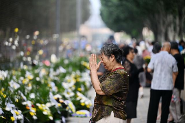 (260728) -- TANGSHAN, July 28, 2026 (Xinhua) -- A citizen mourns in front of a memorial wall inscribed with names of the victims at the Tangshan Earthquake Memorial Park in Tangshan, north China's Hebei Province, July 28, 2026. This year marks the 50th anniversary of the Tangshan Earthquake, a magnitude-7.8 quake that struck the city on July 28, 1976, taking the lives of more than 240,000 people and destroying virtually all buildings in the city.
   Crowds of people visited the Tangshan Earthquake Memorial Park on Tuesday to mourn and remember the victims in the devastating disaster. (Xinhua/Mu Yu)