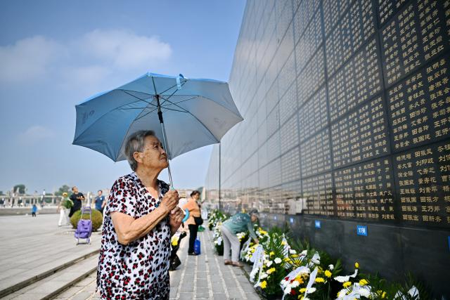 (260728) -- TANGSHAN, July 28, 2026 (Xinhua) -- A citizen mourns in front of a memorial wall inscribed with names of the victims at the Tangshan Earthquake Memorial Park in Tangshan, north China's Hebei Province, July 28, 2026. This year marks the 50th anniversary of the Tangshan Earthquake, a magnitude-7.8 quake that struck the city on July 28, 1976, taking the lives of more than 240,000 people and destroying virtually all buildings in the city.
   Crowds of people visited the Tangshan Earthquake Memorial Park on Tuesday to mourn and remember the victims in the devastating disaster. (Xinhua/Mu Yu)