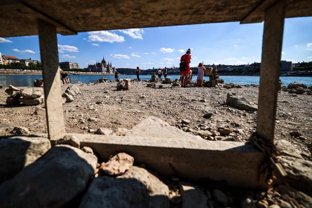 (260728) -- BUDAPEST, July 28, 2026 (Xinhua) -- People explore the exposed riverbed of the Danube River in Budapest, Hungary, July 28, 2026. The water level of the Danube River in Budapest fell to a record low of 31 centimeters on Tuesday, according to Hungary's General Directorate of Water Management. The reading surpassed the previous record low of 33 centimeters which was measured on October 25, 2018, as prolonged drought and a lack of rainfall continue to affect much of the region. (Photo by David Balogh/Xinhua)