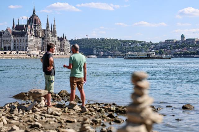 (260728) -- BUDAPEST, July 28, 2026 (Xinhua) -- People explore the exposed riverbed of the Danube River in Budapest, Hungary, July 28, 2026. The water level of the Danube River in Budapest fell to a record low of 31 centimeters on Tuesday, according to Hungary's General Directorate of Water Management. The reading surpassed the previous record low of 33 centimeters which was measured on October 25, 2018, as prolonged drought and a lack of rainfall continue to affect much of the region. (Photo by David Balogh/Xinhua)