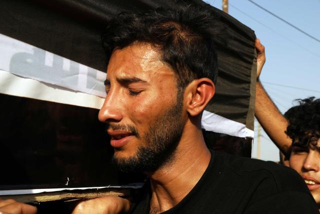 (260729) -- BAGHDAD, July 29, 2026 (Xinhua) -- People participate in a funeral procession of killed Popular Mobilization Forces (PMF) members in Baghdad, Iraq, on July 29, 2026. Iraq's PMF said Wednesday that at least 20 of its members were killed and 32 others wounded during the U.S.-Saudi strikes across several Iraqi provinces. (Xinhua/Khalil Dawood)