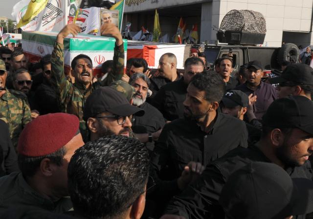 (260729) -- BAGHDAD, July 29, 2026 (Xinhua) -- People participate in a funeral procession of killed Popular Mobilization Forces (PMF) members in Baghdad, Iraq, on July 29, 2026. Iraq's PMF said Wednesday that at least 20 of its members were killed and 32 others wounded during the U.S.-Saudi strikes across several Iraqi provinces. (Xinhua/Khalil Dawood)