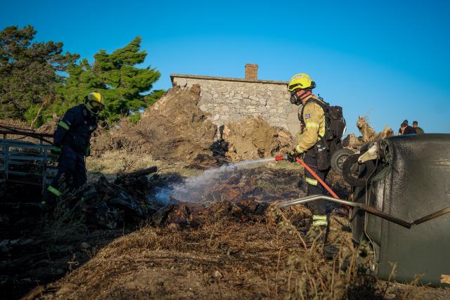 (260730) -- CRETE, July 30, 2026 (Xinhua) -- Firefighters take part in firefighting operations in Rethymno on the island of Crete, Greece, July 29, 2026. Two firefighters lost their lives while battling a fast-moving wildfire in Rethymno on the Greek island of Crete on Wednesday, as gale-force winds fueled the blaze across a front stretching more than 15 kilometers. (Photo by Rapanis Spiros/Xinhua)