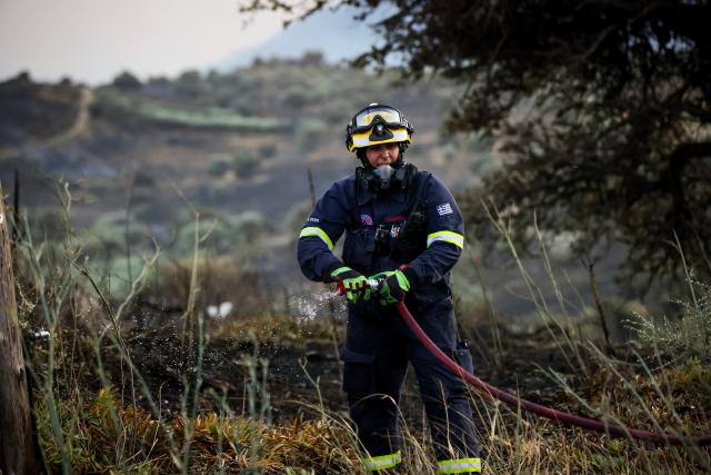 (260730) -- CRETE, July 30, 2026 (Xinhua) -- A firefighter takes part in firefighting operations in Rethymno on the island of Crete, Greece, July 29, 2026. Two firefighters lost their lives while battling a fast-moving wildfire in Rethymno on the Greek island of Crete on Wednesday, as gale-force winds fueled the blaze across a front stretching more than 15 kilometers. (Photo by Rapanis Spiros/Xinhua)