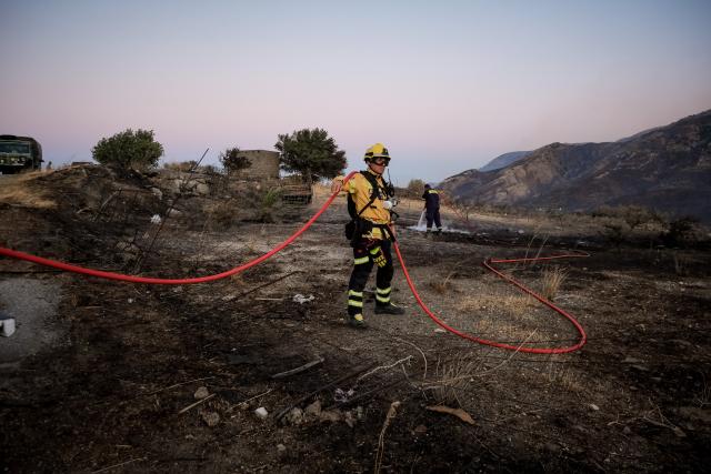 (260730) -- CRETE, July 30, 2026 (Xinhua) -- Firefighters take part in firefighting operations in Rethymno on the island of Crete, Greece, July 29, 2026. Two firefighters lost their lives while battling a fast-moving wildfire in Rethymno on the Greek island of Crete on Wednesday, as gale-force winds fueled the blaze across a front stretching more than 15 kilometers. (Photo by Rapanis Spiros/Xinhua)