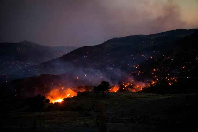 (260730) -- CRETE, July 30, 2026 (Xinhua) -- Smoke rises from a wildfire in Rethymno on the island of Crete, Greece, July 29, 2026. Two firefighters lost their lives while battling a fast-moving wildfire in Rethymno on the Greek island of Crete on Wednesday, as gale-force winds fueled the blaze across a front stretching more than 15 kilometers. (Photo by Rapanis Spiros/Xinhua)
