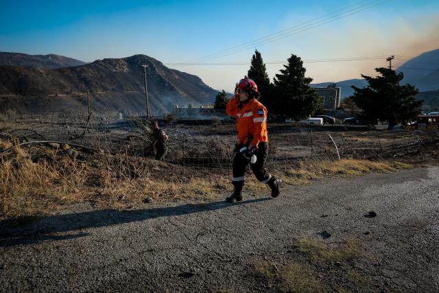 (260730) -- CRETE, July 30, 2026 (Xinhua) -- A firefighter takes part in firefighting operations in Rethymno on the island of Crete, Greece, July 29, 2026. Two firefighters lost their lives while battling a fast-moving wildfire in Rethymno on the Greek island of Crete on Wednesday, as gale-force winds fueled the blaze across a front stretching more than 15 kilometers. (Photo by Rapanis Spiros/Xinhua)