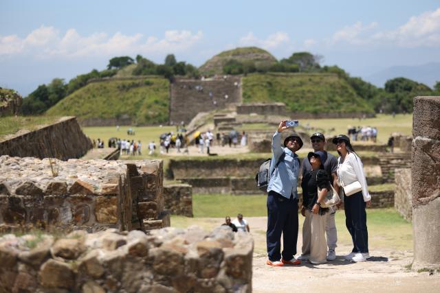 (260730) -- OAXACA, July 30, 2026 (Xinhua) -- Visitors pose for a selfie at the Monte Alban archaeological site in Oaxaca, Mexico, on July 29, 2026. Built around 500 B.C., Monte Alban is located in the southern Mexican state of Oaxaca. It was inscribed on the UNESCO World Heritage List in 1987. (Xinhua/Liu Wenhui)
