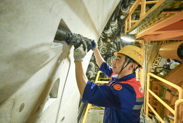 (260730) -- SHANGHAI, July 30, 2026 (Xinhua) -- A technician works at the construction site of the Chongming-Taicang Yangtze River tunnel under China's Yangtze River, July 30, 2026. China's domestically developed, world's largest-diameter high-speed-rail shield tunneling machine "Linghang" completed tunneling of the underwater section of the Chongming-Taicang Yangtze River tunnel on Thursday. The milestone lays the foundation for China's first high-speed railway crossing beneath the Yangtze River at 350 kilometers per hour without slowing down. (Xinhua/Chen Haoming)
