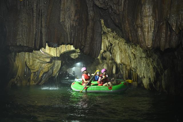 (260730) -- HUANGPING, July 30, 2026 (Xinhua) -- Tourists enjoy rafting at a scenic area in Huangping County, southwest China's Guizhou Province, July 29, 2026. During the summer vacation, Huangping has leveraged its mountain springs and canyon landscapes to develop a rafting tourism brand, attracting visitors for a refreshing getaway while boosting local tourism and incomes. (Photo by Liang Wen/Xinhua)