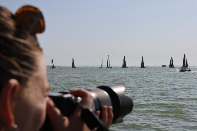 (260731) -- BALATONFURED, July 31, 2026 (Xinhua) -- A spectator takes photos of the participants competing during the 58th Blue Ribbon Regatta race around Lake Balaton near Balatonfured, Hungary, on July 30, 2026. (Photo by Attila Volgyi/Xinhua)