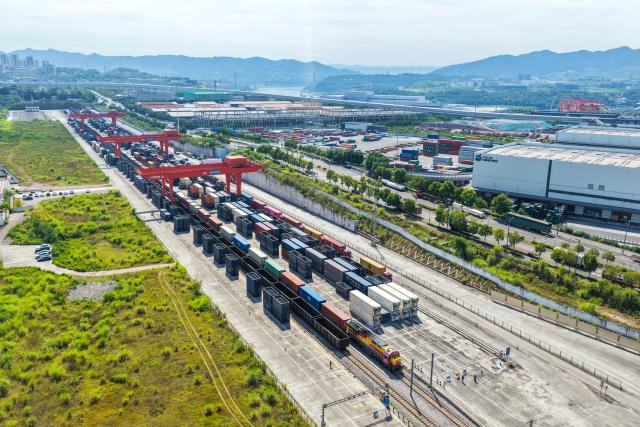 (260731) -- CHONGQING, July 31, 2026 (Xinhua) -- An aerial drone photo taken on July 30, 2026 shows a freight train of the New International Land-Sea Trade Corridor waiting for departure at Yuzui Station in Chongqing, southwest China. A total of 961 rail freight train trips were operated from Chongqing via the New International Land-Sea Trade Corridor in the first half of the year, up 25.6 percent year on year, according to the logistics division of China Railway Chengdu Group Co., Ltd. 
  Chongqing's imports and exports via the corridor amounted to 28.71 billion yuan (about 4.25 billion U.S. dollars) during the same period, rising 13.7 percent year on year, according to data from Chongqing Customs. (Xinhua/Tang Yi)