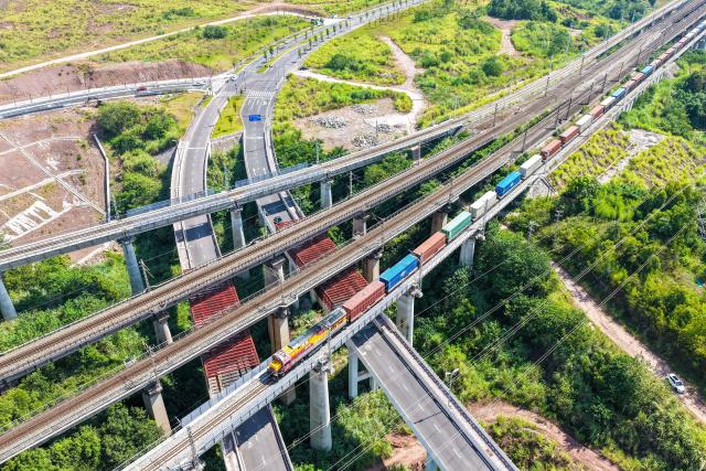 (260731) -- CHONGQING, July 31, 2026 (Xinhua) -- An aerial drone photo taken on July 30, 2026 shows a freight train of the New International Land-Sea Trade Corridor departing from Yuzui Station in Chongqing, southwest China. A total of 961 rail freight train trips were operated from Chongqing via the New International Land-Sea Trade Corridor in the first half of the year, up 25.6 percent year on year, according to the logistics division of China Railway Chengdu Group Co., Ltd. 
  Chongqing's imports and exports via the corridor amounted to 28.71 billion yuan (about 4.25 billion U.S. dollars) during the same period, rising 13.7 percent year on year, according to data from Chongqing Customs. (Xinhua/Tang Yi)