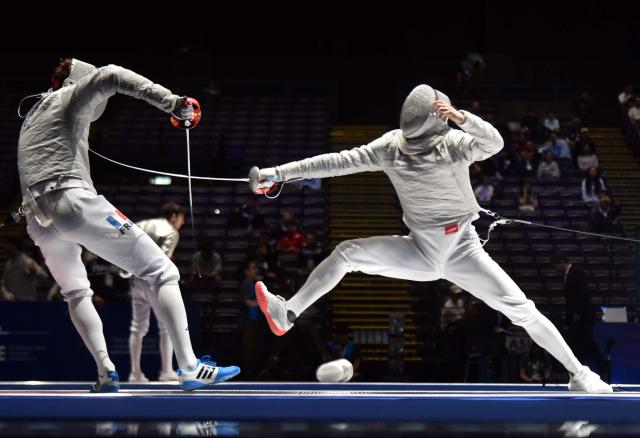 (260731) -- BEIJING, July 31, 2026 (Xinhua) -- Lin Xiao (R) of China competes with Remi Garrigue of France during the team men's sabre quarterfinal match between China and France at the 2026 Fencing World Championships in Hong Kong, south China, July 30, 2026. (Xinhua/Lo Ping Fai)