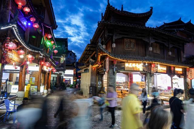 (260731) -- WENSHAN, July 31, 2026 (Xinhua) -- Tourists visit the Xianrendong Village within the Puzhehei scenic area in Qiubei County, Wenshan Zhuang and Miao Autonomous Prefecture, southwest China's Yunnan Province, on July 30, 2026. The Puzhehei scenic area has seen an increased number of tourists during the country's summer peak tourism season. (Xinhua/Chen Xinbo)