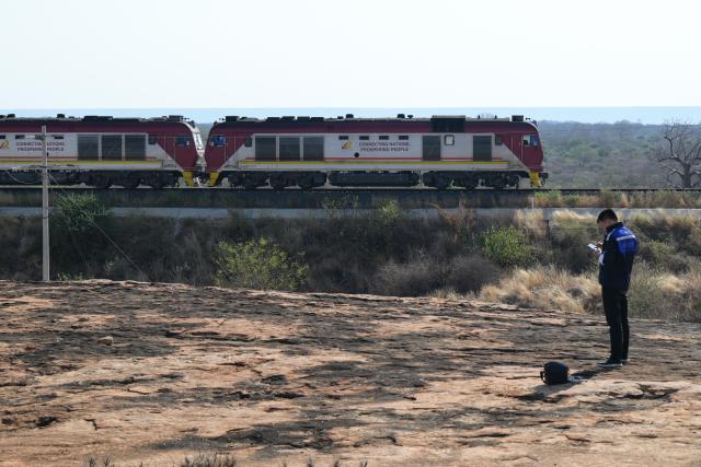 (260731) -- NAIROBI, July 31, 2026 (Xinhua) -- Communication engineer Zhou Junbing flies a drone to patrol communication equipment near a railway station on the Mombasa-Nairobi Standard Gauge Railway in Kenya on July 24, 2026. After graduating from Beijing Jiaotong University with a degree in communication engineering, Zhou Junbing joined the Africa Star Railway Operation Company (Afristar) at the age of 27, dedicating himself to the operation of Mombasa-Nairobi Standard Gauge Railway (SGR). 
  At that time, the railway had just begun operations. Thanks to Zhou's solid expertise and experience in railway communication, he quickly became a key member of a team responsible for maintaining and supporting the railway's communication system. 
  The railway stretches 472 km, linking the port city of Mombasa in the southeastern part of the country with the capital city, Nairobi. It is the first modern railway constructed in Kenya since independence and stands as a key achievement of China-Kenya cooperation under the Belt and Road Initiative. The Afristar provides operational and technical support for the Mombasa-Nairobi SGR.
  Today, Zhou is in charge of the technical support for communication equipment serving 26 railway systems along the Mombasa-Nairobi SGR. He spends much of his time on the front line of equipment maintenance and technical support. During his eight years working in Kenya, Zhou has continuously shared his expertise with local employees. Whenever the local staff encounter technical challenges, Zhou is always the first person they turn to for advice. To his Kenyan colleagues, Zhou is not only a Chinese engineer, but also a trusted mentor and friend. (Xinhua/Yang Guang)