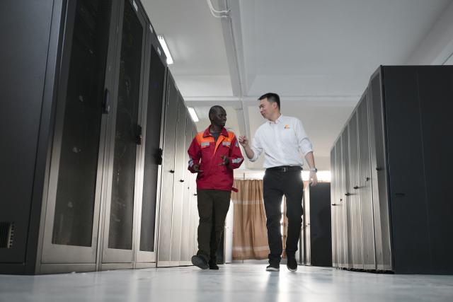 (260731) -- NAIROBI, July 31, 2026 (Xinhua) -- Communication engineer Zhou Junbing, together with a local staff member, patrols equipment at Nairobi Station on the Mombasa-Nairobi Standard Gauge Railway in Kenya on July 22, 2026. After graduating from Beijing Jiaotong University with a degree in communication engineering, Zhou Junbing joined the Africa Star Railway Operation Company (Afristar) at the age of 27, dedicating himself to the operation of Mombasa-Nairobi Standard Gauge Railway (SGR). 
  At that time, the railway had just begun operations. Thanks to Zhou's solid expertise and experience in railway communication, he quickly became a key member of a team responsible for maintaining and supporting the railway's communication system. 
  The railway stretches 472 km, linking the port city of Mombasa in the southeastern part of the country with the capital city, Nairobi. It is the first modern railway constructed in Kenya since independence and stands as a key achievement of China-Kenya cooperation under the Belt and Road Initiative. The Afristar provides operational and technical support for the Mombasa-Nairobi SGR.
  Today, Zhou is in charge of the technical support for communication equipment serving 26 railway systems along the Mombasa-Nairobi SGR. He spends much of his time on the front line of equipment maintenance and technical support. During his eight years working in Kenya, Zhou has continuously shared his expertise with local employees. Whenever the local staff encounter technical challenges, Zhou is always the first person they turn to for advice. To his Kenyan colleagues, Zhou is not only a Chinese engineer, but also a trusted mentor and friend. (Xinhua/Yang Guang)
