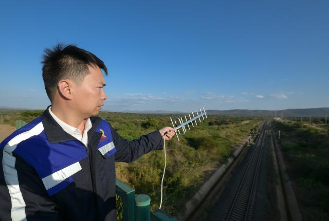 (260731) -- NAIROBI, July 31, 2026 (Xinhua) -- Communication engineer Zhou Junbing monitors the electromagnetic data along the Mombasa-Nairobi Standard Gauge Railway in Kenya on July 24, 2026. After graduating from Beijing Jiaotong University with a degree in communication engineering, Zhou Junbing joined the Africa Star Railway Operation Company (Afristar) at the age of 27, dedicating himself to the operation of Mombasa-Nairobi Standard Gauge Railway (SGR). 
  At that time, the railway had just begun operations. Thanks to Zhou's solid expertise and experience in railway communication, he quickly became a key member of a team responsible for maintaining and supporting the railway's communication system. 
  The railway stretches 472 km, linking the port city of Mombasa in the southeastern part of the country with the capital city, Nairobi. It is the first modern railway constructed in Kenya since independence and stands as a key achievement of China-Kenya cooperation under the Belt and Road Initiative. The Afristar provides operational and technical support for the Mombasa-Nairobi SGR.
  Today, Zhou is in charge of the technical support for communication equipment serving 26 railway systems along the Mombasa-Nairobi SGR. He spends much of his time on the front line of equipment maintenance and technical support. During his eight years working in Kenya, Zhou has continuously shared his expertise with local employees. Whenever the local staff encounter technical challenges, Zhou is always the first person they turn to for advice. To his Kenyan colleagues, Zhou is not only a Chinese engineer, but also a trusted mentor and friend. (Xinhua/Yang Guang)